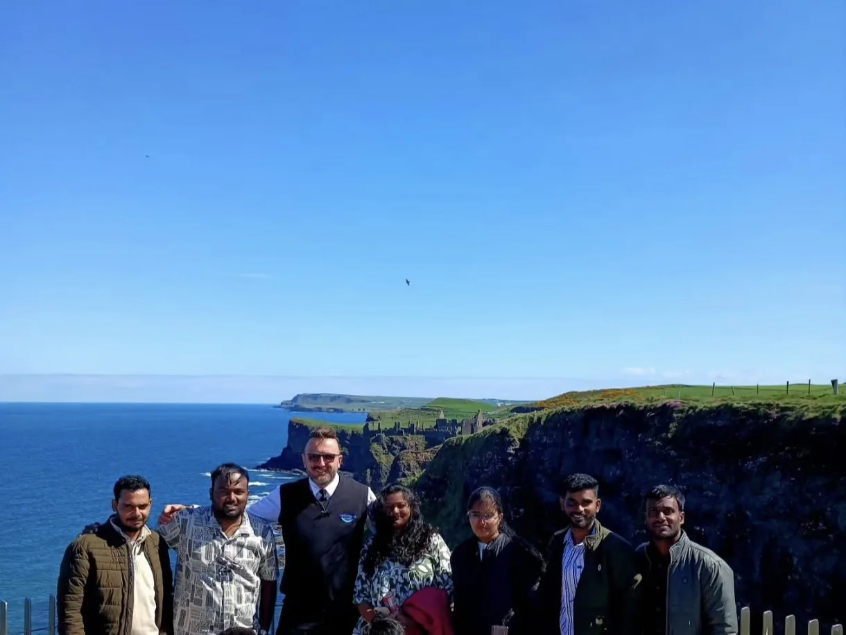 Group of clients with their chauffeur on the Causeway Coast in Northern Ireland