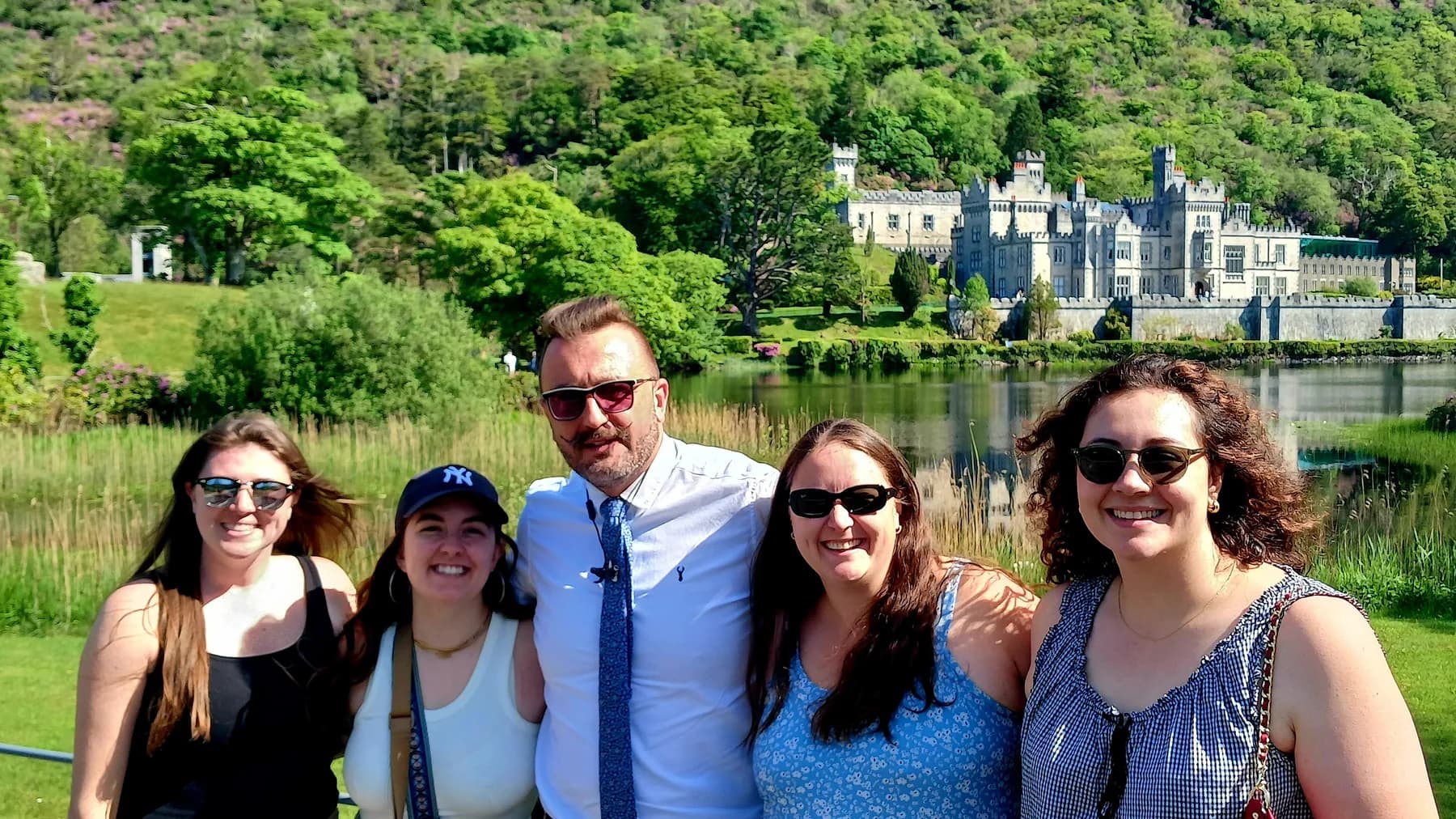 Guests with their chauffeur in front of Kylemore Abbey on a private Connemara tour