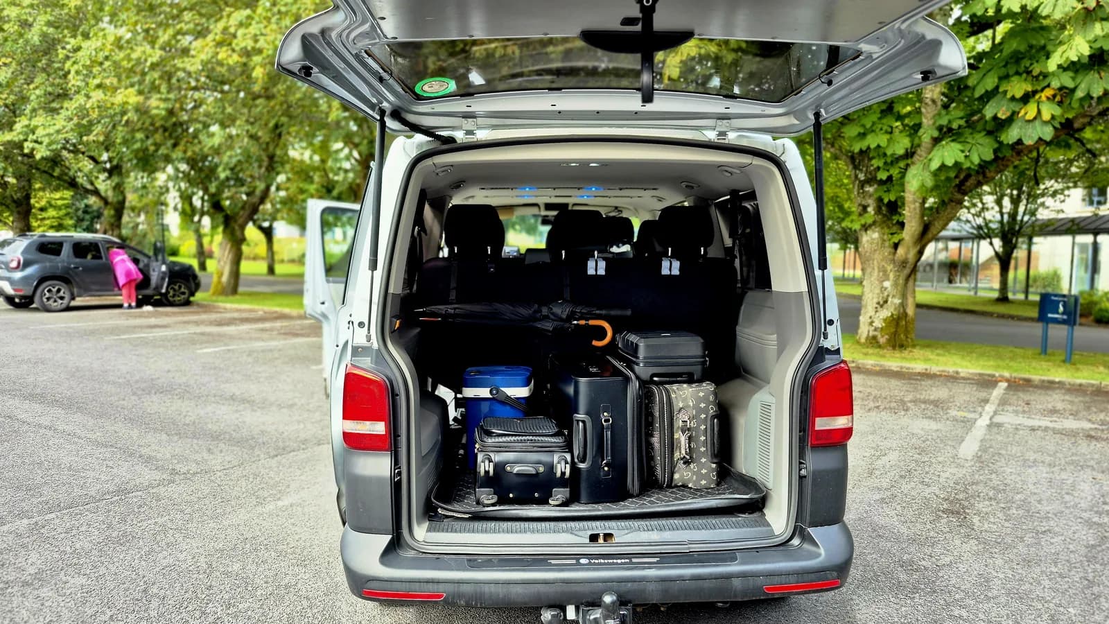 Rear boot of the executive van loaded with full-size suitcases