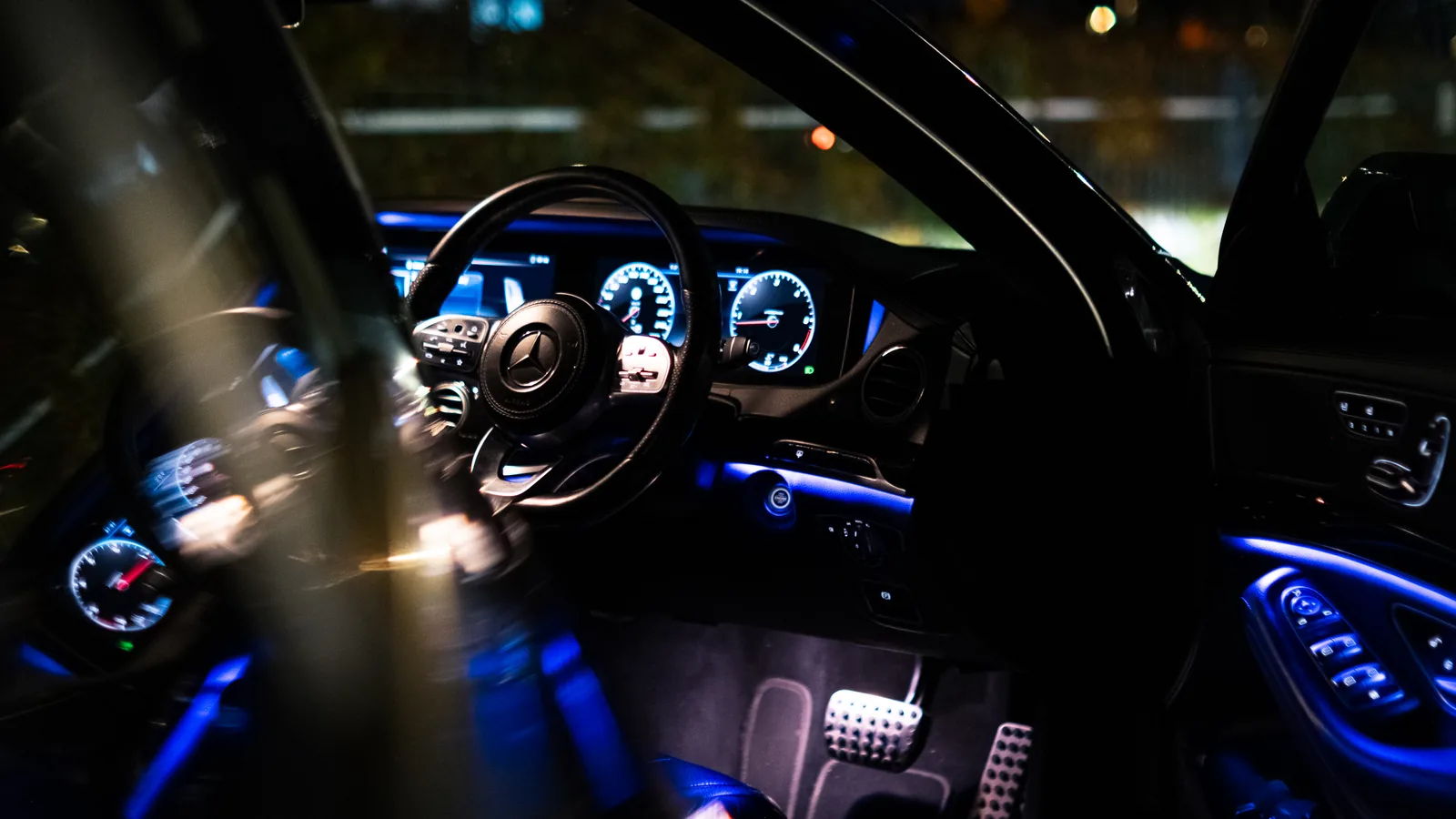 Driver's cockpit of the Mercedes-Benz S-Class at night through the open door