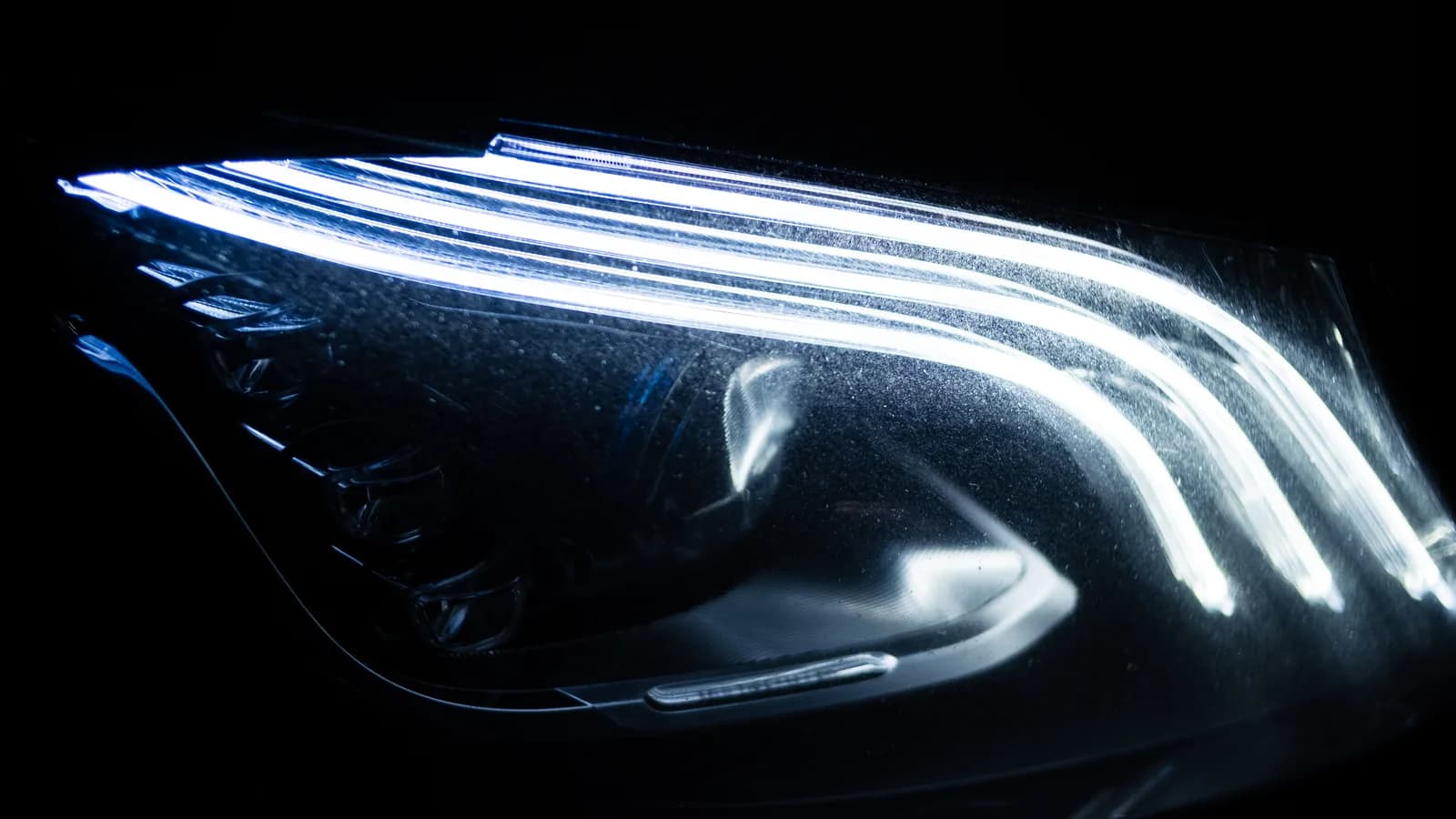 Close-up of the Mercedes-Benz S-Class LED headlight glowing at night
