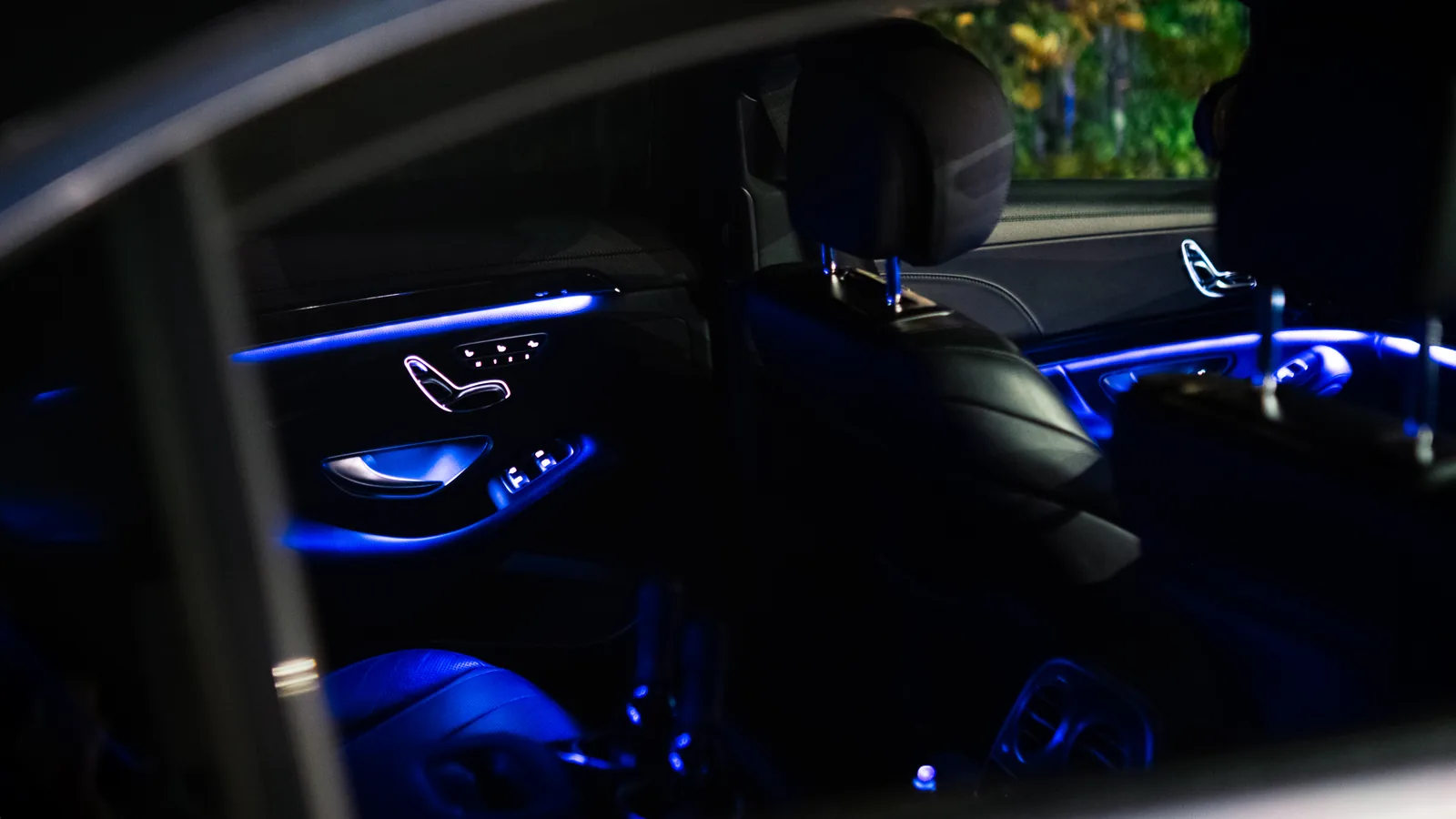 Blue ambient lighting along the rear doors of the Mercedes-Benz S-Class at night