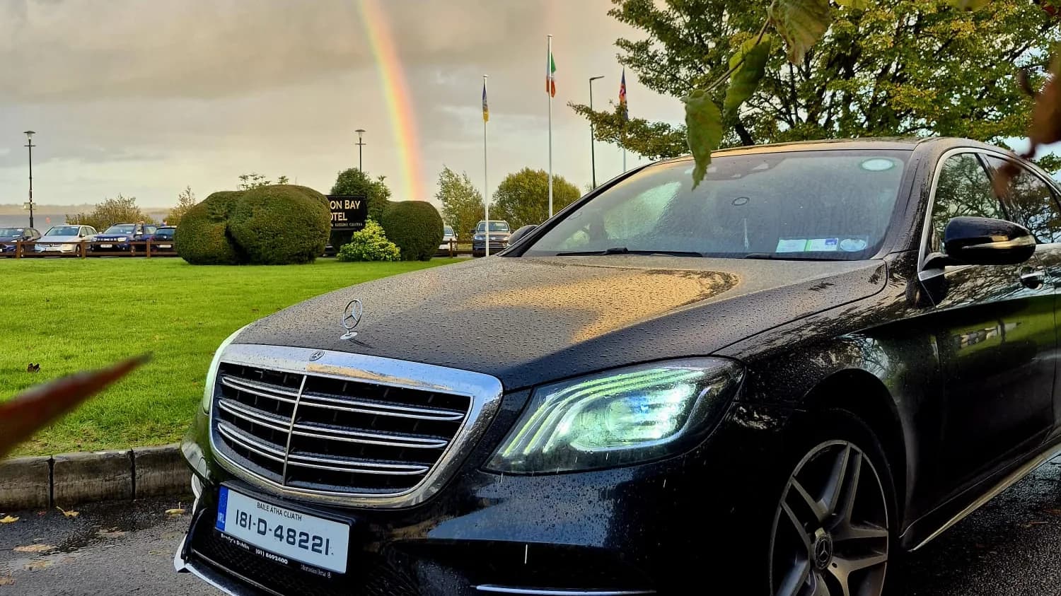 Black Mercedes-Benz S-Class under a rainbow at Hodson Bay, Athlone