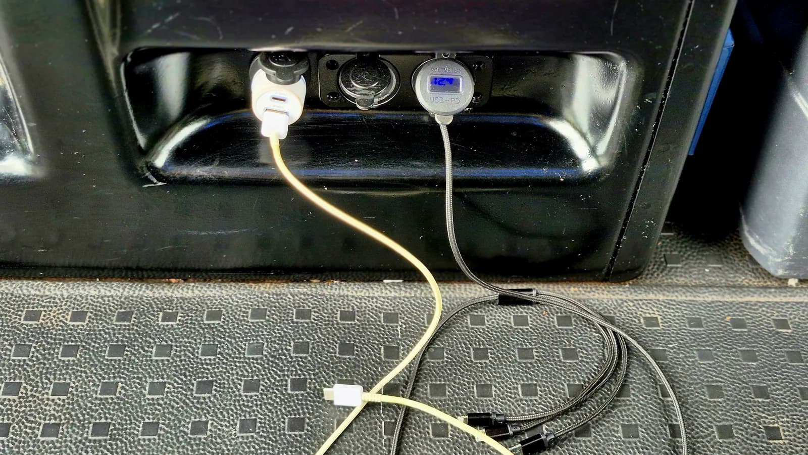 Branded onboard USB charging ports with cables inside the vehicle