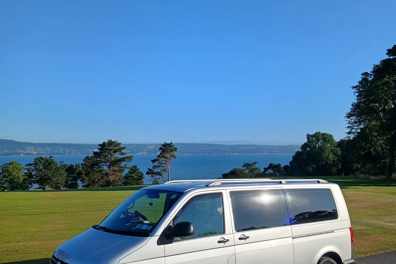 Private transfer vehicle parked above a bay with sea views in the south-west of Ireland
